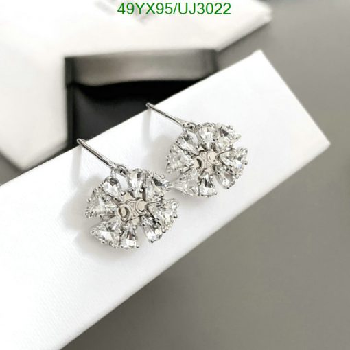 Crystal snowflake earrings on white display.