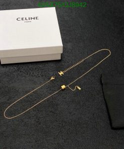 Celine gold necklace on black surface with box and pouch.