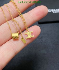 Gold pendant necklaces held in hand.