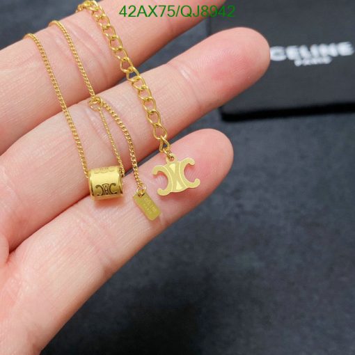 Gold pendant necklaces held in hand.