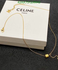 Gold necklace on Celine box.