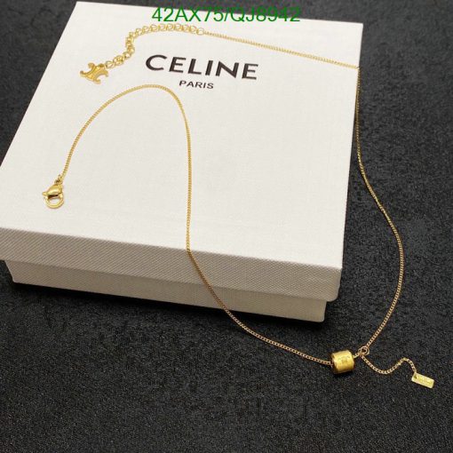 Gold necklace on Celine box.