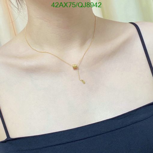 Gold pendant necklace on woman's neck