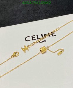 Gold necklace on branded Celine card.