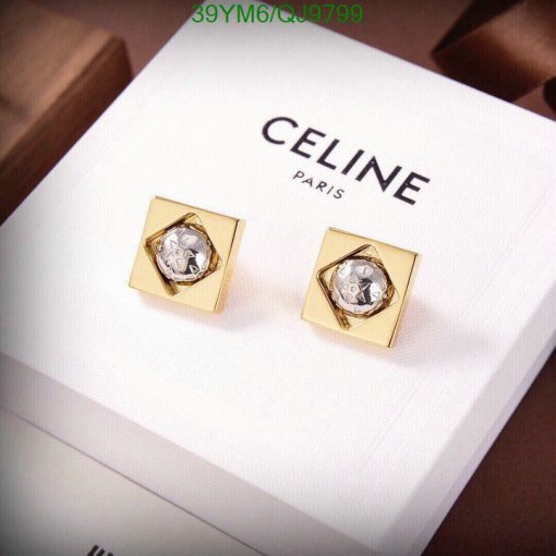 Celine gold square cufflinks on white display.