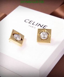 Gold designer earrings on branded box