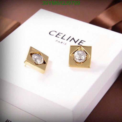 Gold designer earrings on branded box