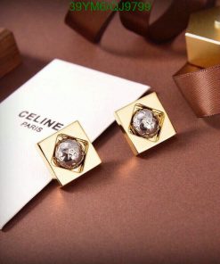 Designer gold earrings on luxury background.