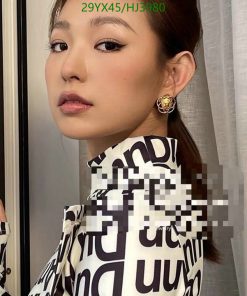 Woman with elegant makeup and designer earrings.