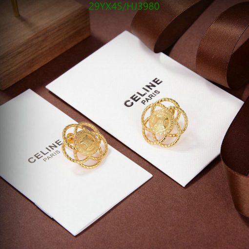 Gold Celine earrings on white card with logo.