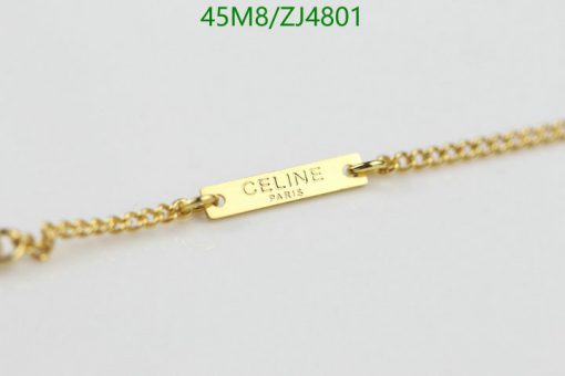 Gold chain with designer tag detail.