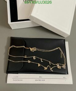 Designer gold chain necklace on display with packaging.