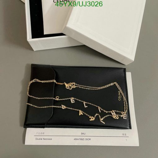 Designer gold chain necklace on display with packaging.