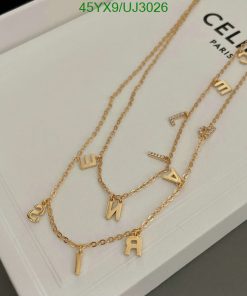 Gold alphabet letter charm necklace on white display.