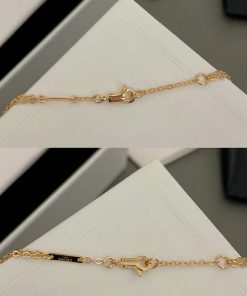 Gold chain bracelet clasp detail.