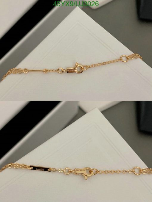 Gold chain bracelet clasp detail.