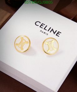 Gold designer logo earrings on white display box.