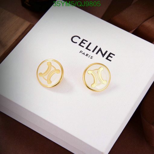 Gold designer logo earrings on white display box.