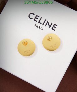 Gold Celine earrings on white display.