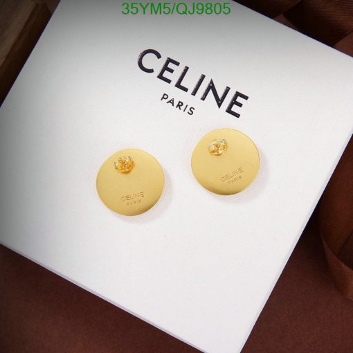 Gold Celine earrings on white display.