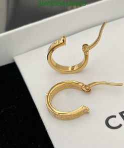 Gold hoop earrings on white display.