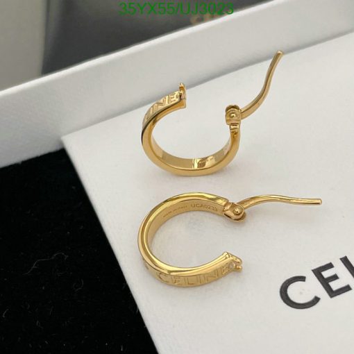 Gold hoop earrings on white display.