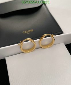 Gold hoop earrings on white display with Celine box.