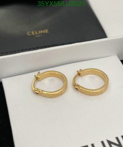 Gold Celine hoop earrings on white display.