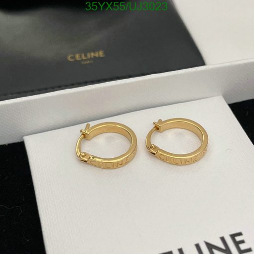 Gold Celine hoop earrings on white display.