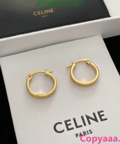 Gold hoop earrings on Celine brand display.