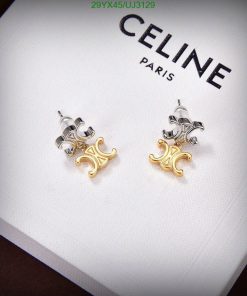 Designer two-tone stud earrings on branded background.