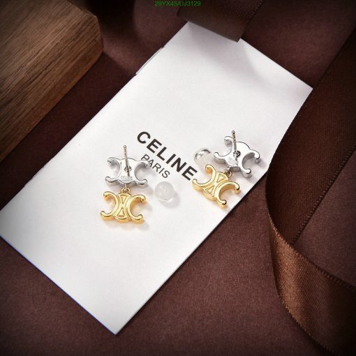 Elegant Celine Paris earrings on white display with brown ribbon.