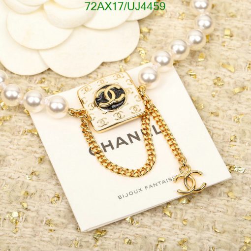 Designer gold-tone brooch with pearl accents.