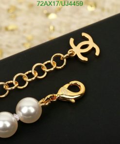 Gold bracelet with pearls and designer charm.