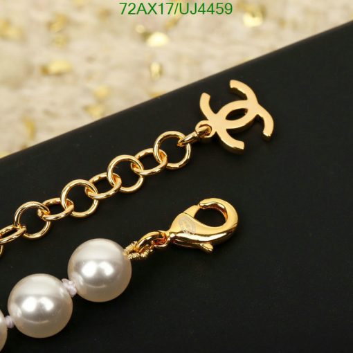 Gold bracelet with pearls and designer charm.