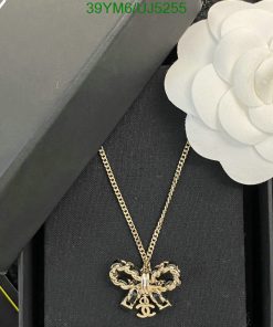 Designer gold pendant necklace with flower accessory.