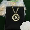 Gold pendant necklace on black display box