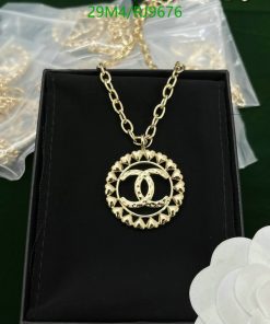 Gold pendant necklace on black display box