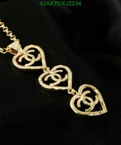 Gold heart pendant necklace on black background.