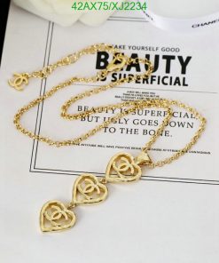 Gold rose pendant necklace on magazine page.