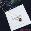 Gold Chanel logo pendant necklace on branded card.