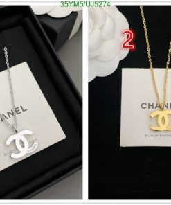 Two Chanel logo necklaces, one silver, one gold.