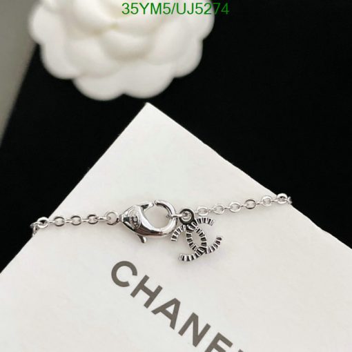 Silver bracelet with lobster clasp and charm detail.