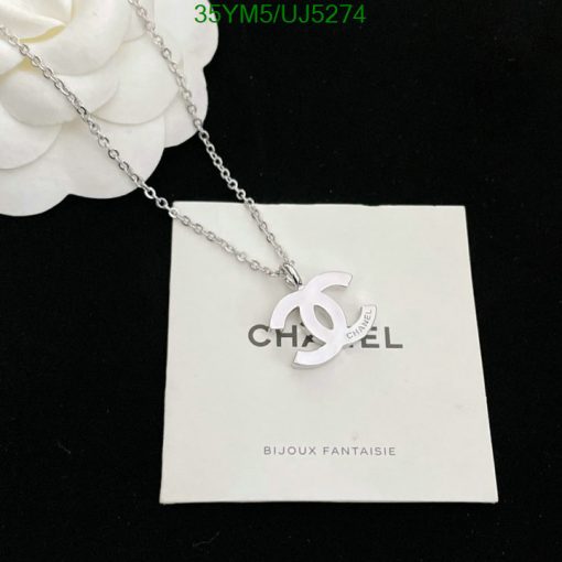 Silver pendant necklace on branded card.