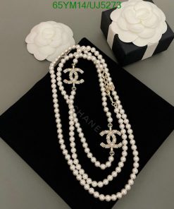 Elegant pearl necklace with decorative clasps on black display.