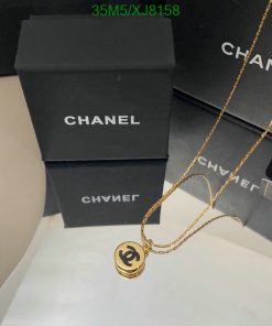 Chanel necklace on display with packaging boxes.