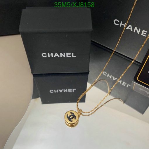 Chanel necklace on display with packaging boxes.