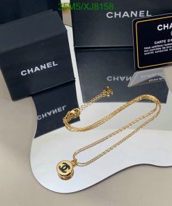 Chanel branded jewelry and packaging on display.