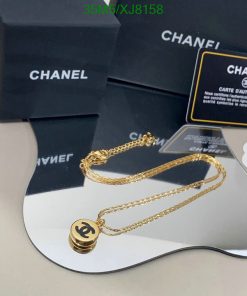 Gold necklace on display with branded packaging.