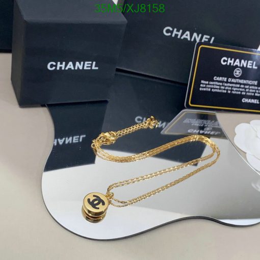 Gold necklace on display with branded packaging.